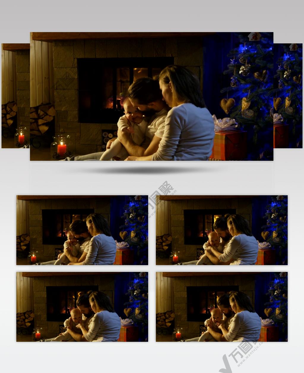 圣诞节一对夫妇抱着婴儿在壁炉旁