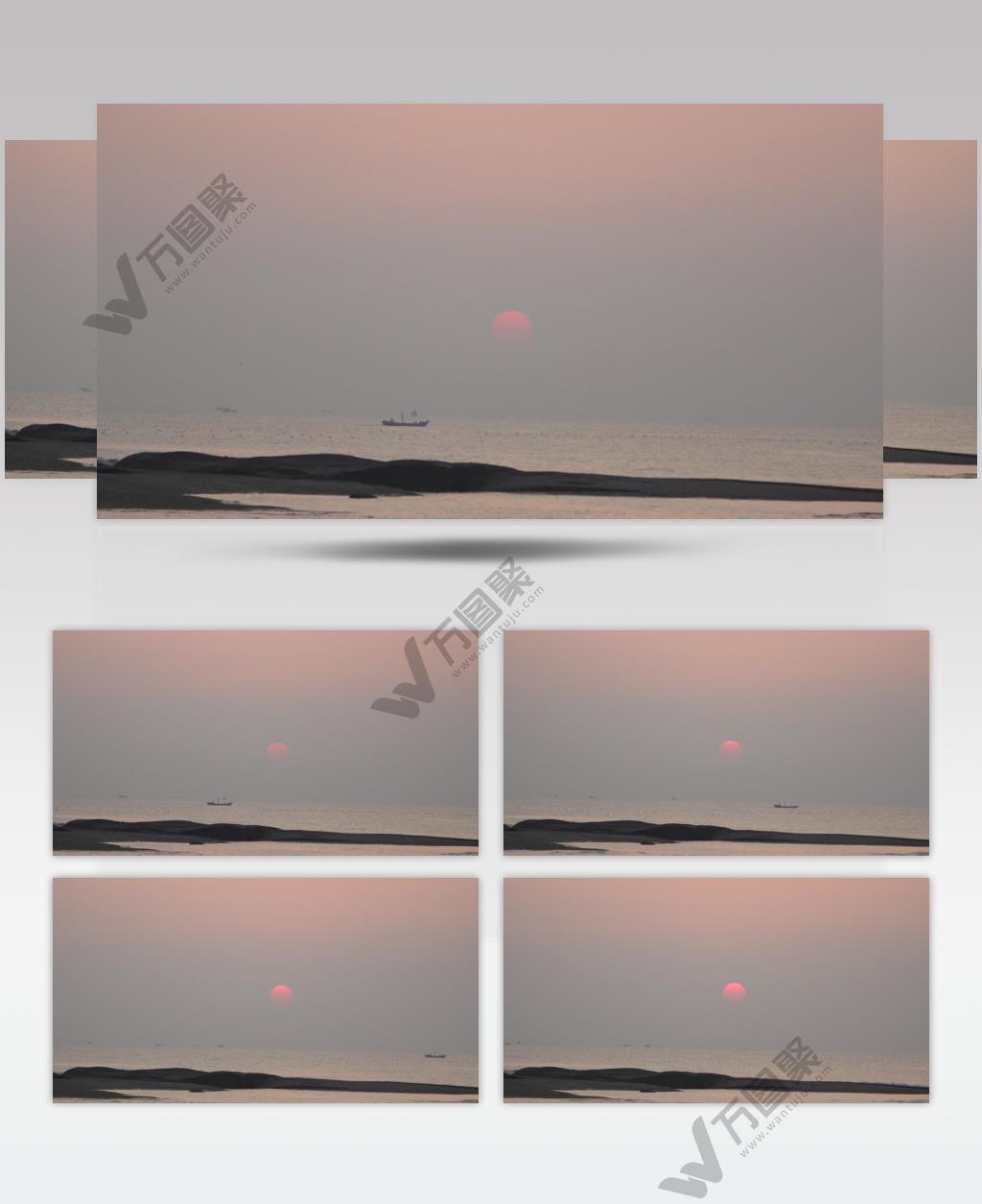 海上日出渔船在海上驶过