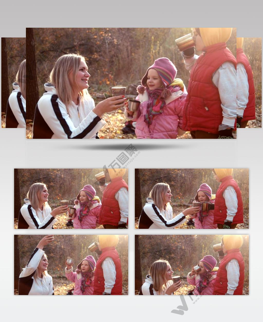 一家人在秋天的森林里喝热饮
