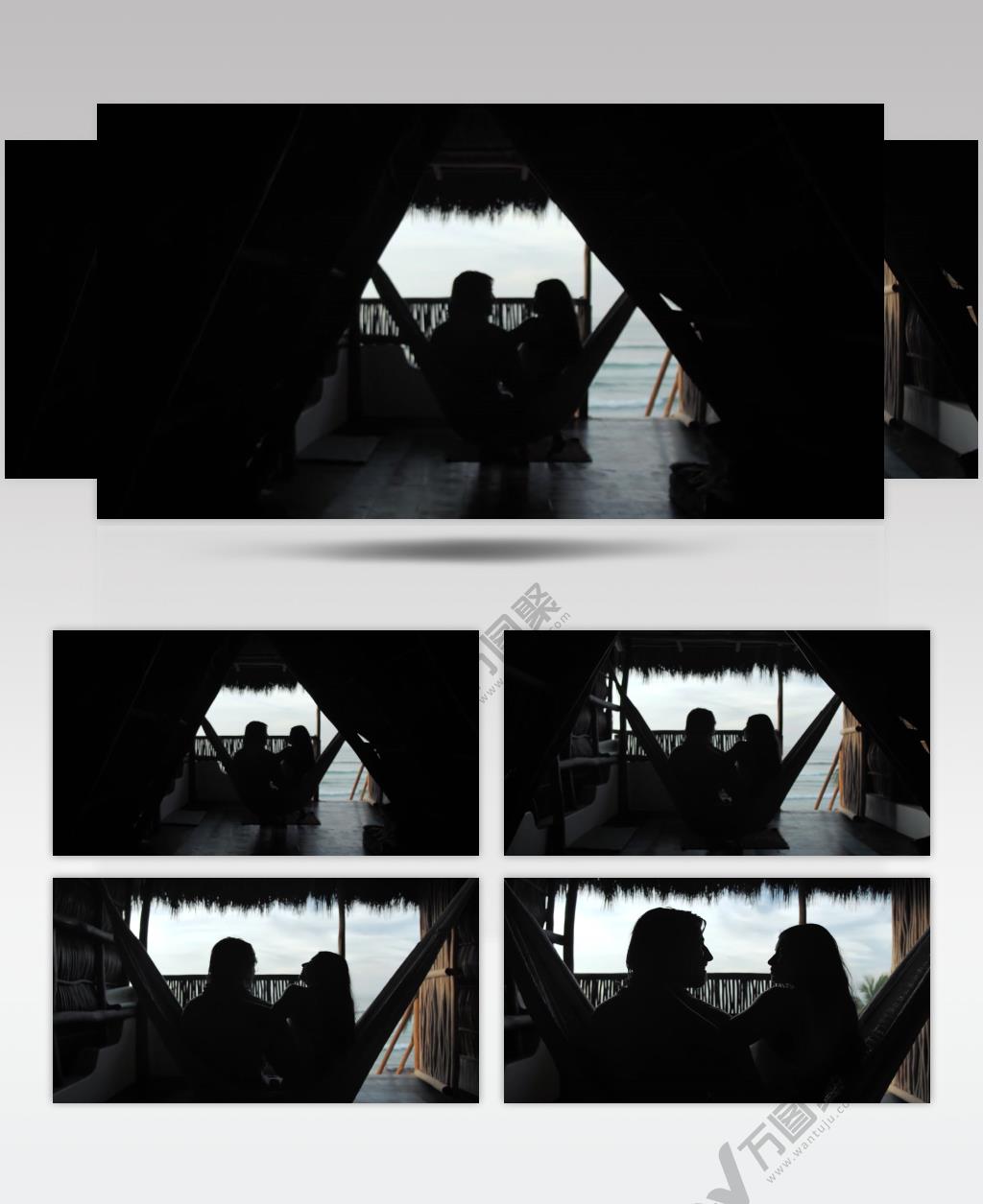 情侣坐在大海海岸边上的木屋里