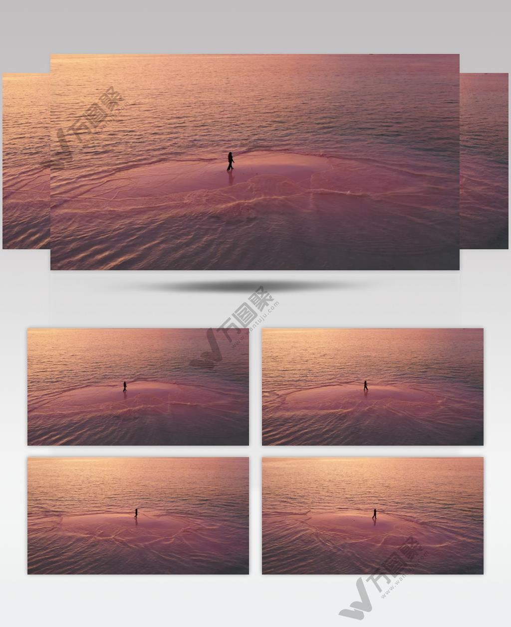 航拍一个人走在日落下的大海海滩