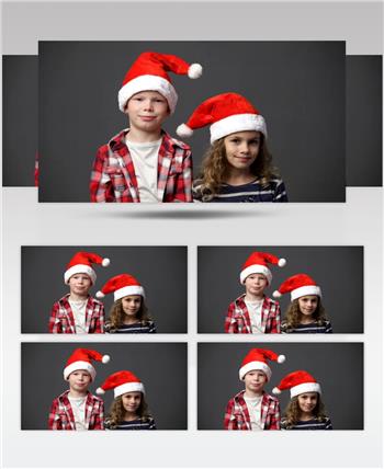 在镜头前两个孩子戴着圣诞帽