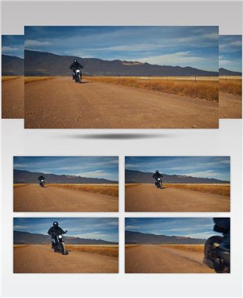 男子骑摩托车在沙漠中骑行