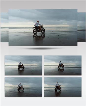 阴天在海滩上骑摩托车的人