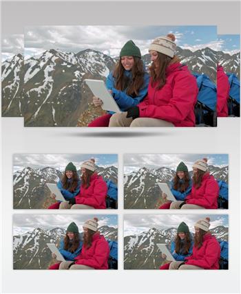 俩旅行女子在雪山顶上休息