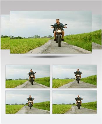 在乡下，一个人在农场附近骑摩托车