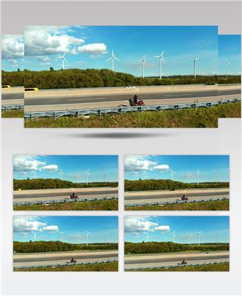 影视CG动画公路上有风电场的摩托车
