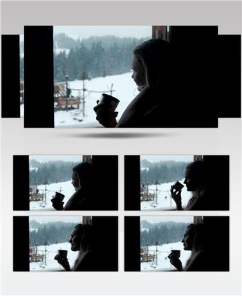 下雪天在窗边喝咖啡的女人