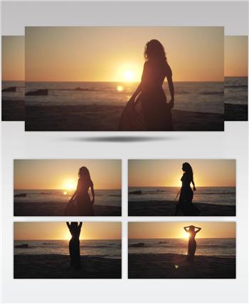 日落夕阳下大海海岸上美女剪影