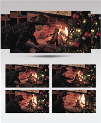 圣诞节夜晚男人在壁炉里生火