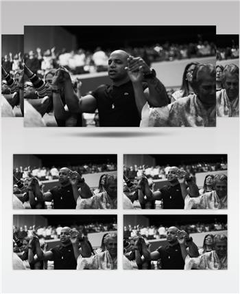 礼堂里的人们在闭上眼睛举起手祈祷祝福的黑白视频