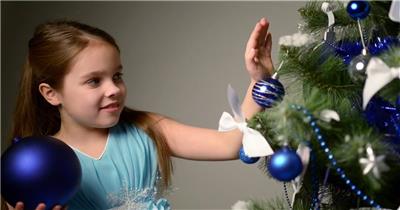 小女孩在装饰她的圣诞树