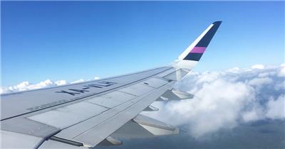  航拍镜头窗外一架飞越云层的飞机