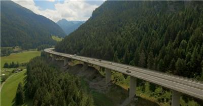 航拍山脉森林旁的沿山公路实拍视频