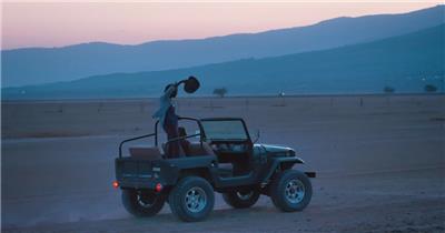 朋友旅行乘坐敞篷吉普车穿越沙漠
